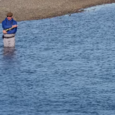 An angler fishes for sea-run brown trout on Tierra del Fuego's Rio Grande River.