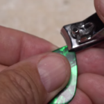 Using a guitar pick to create a hackle-folding tool