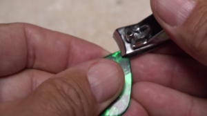 Using a guitar pick to create a hackle-folding tool