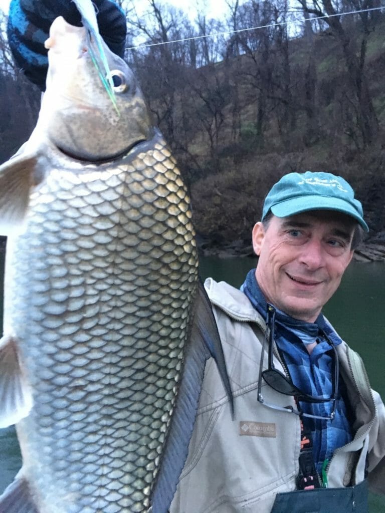 An angler holds a quillback sucker-carp from the Potomac River.