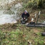 TU's Dean Finnerty checks on sonar equipment that counts fish moving up a southwest Oregon river.