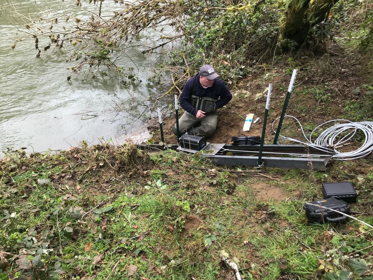 TU's Dean Finnerty checks on sonar equipment that counts fish moving up a southwest Oregon river.