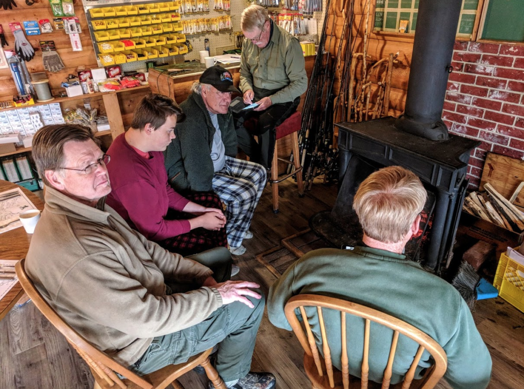 Anglers gathered around a wood stove at Laurie River Lodge, Manitoba.