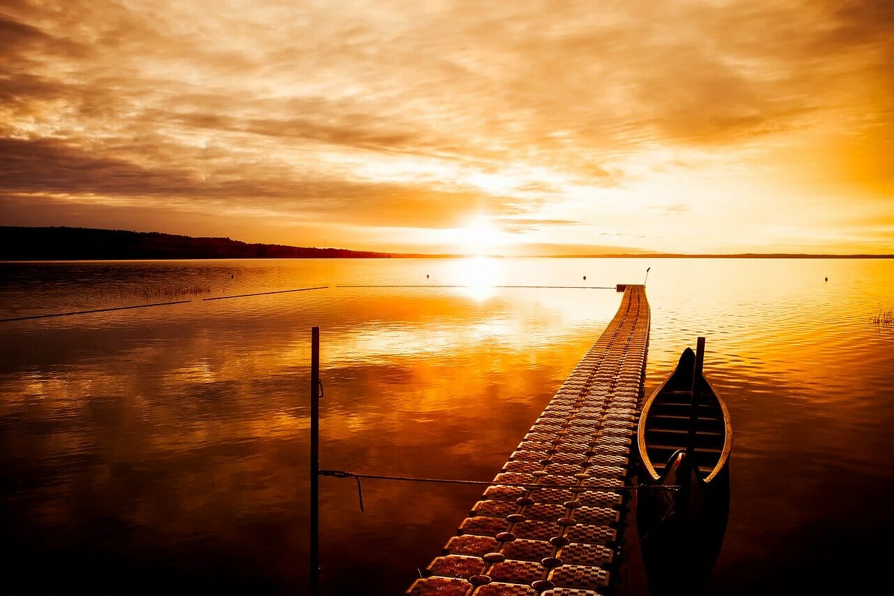 A canoe on a lake at sunset.