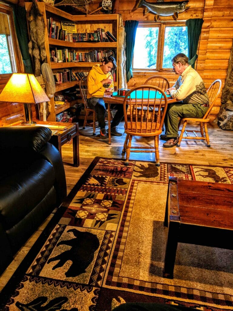 A boy plays cribbage with a friend.