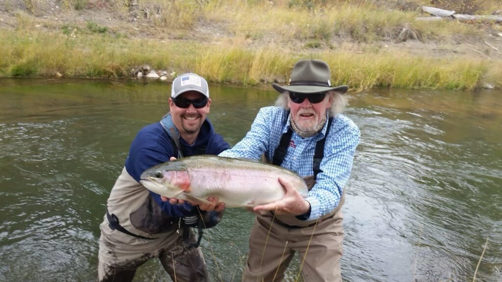 Guide and client with a big rainbow trout.