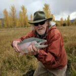 A man holds a big trout