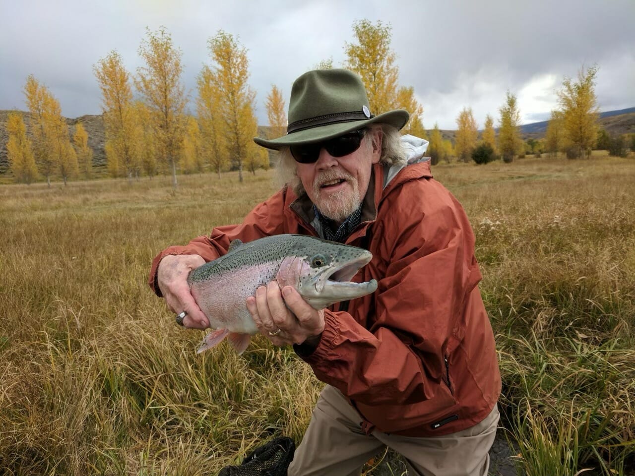 A man holds a big trout