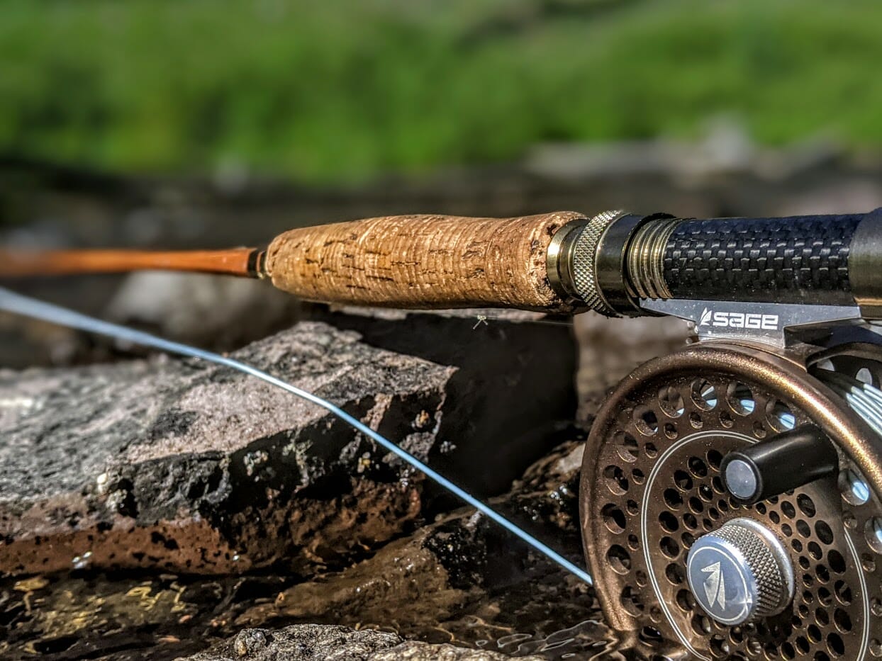 Bamboo fly rod, classic fly reel, and fishing flies Stock Photo