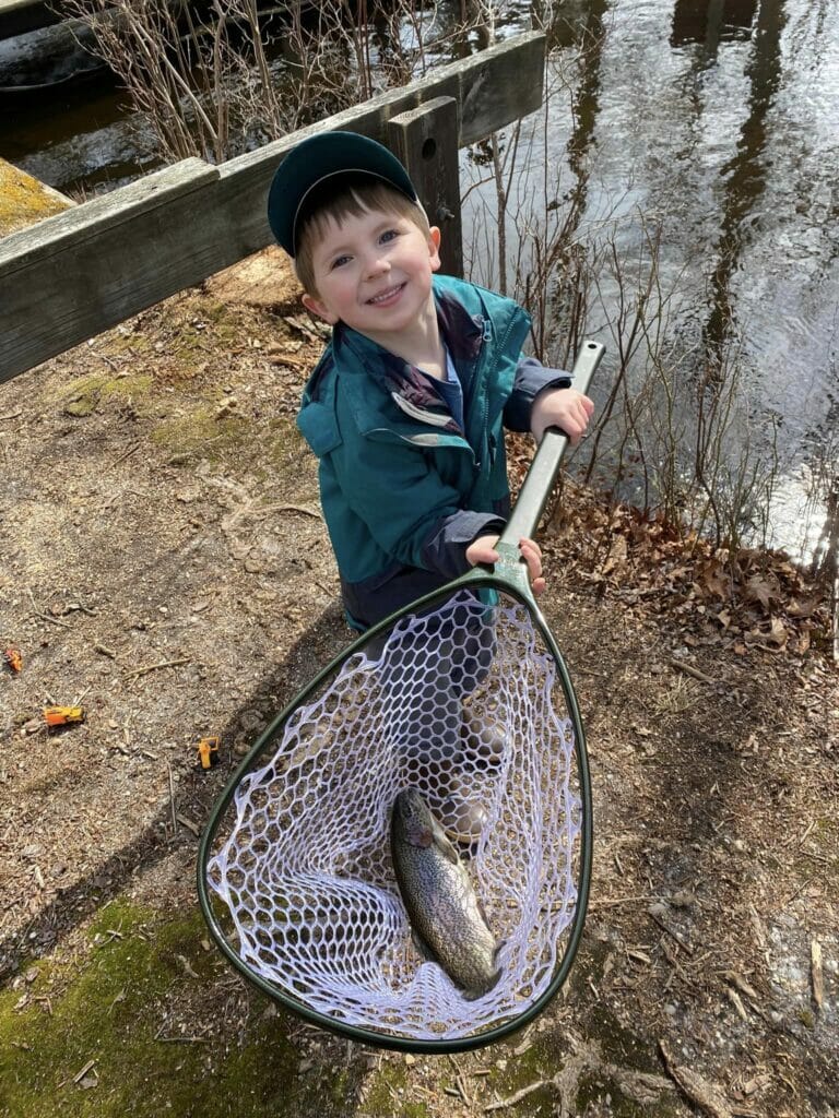 Boy has trout in  his net