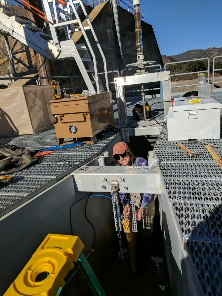 Smiling Haley Ohms works on large equipment