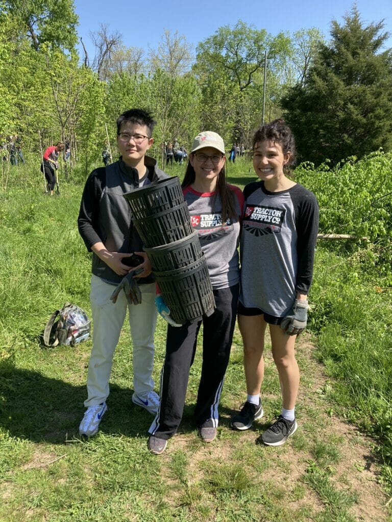 3 young people hold empty tree pots