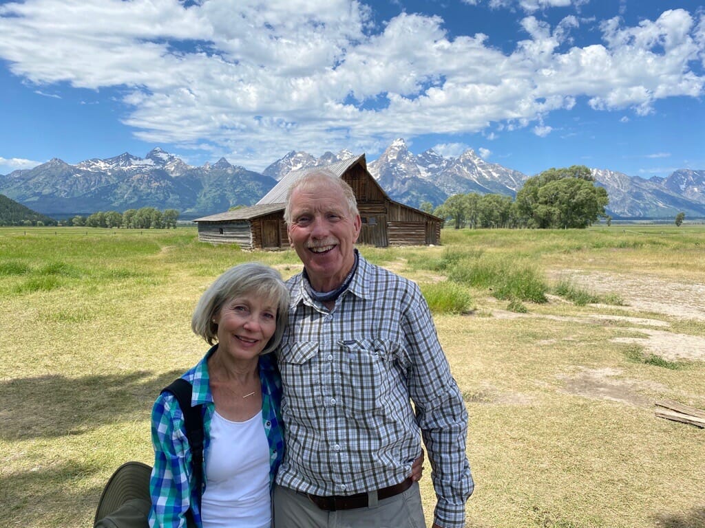 Jim Correa and woman in front of Wyoming mountains