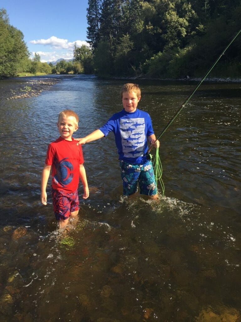 Lindsay Slater's two young sons fly fishing in a river