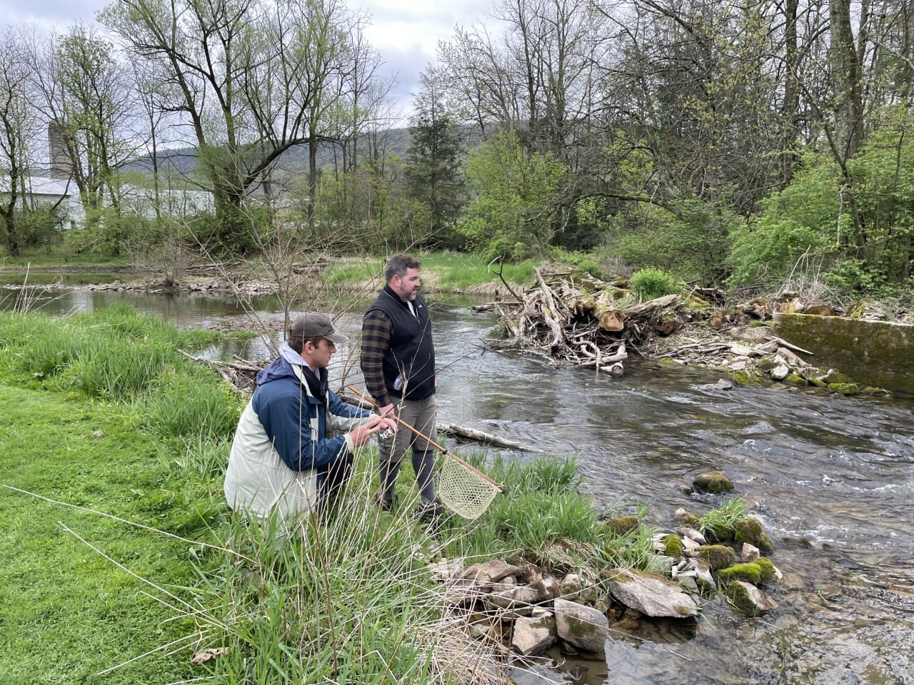 Two men look at river