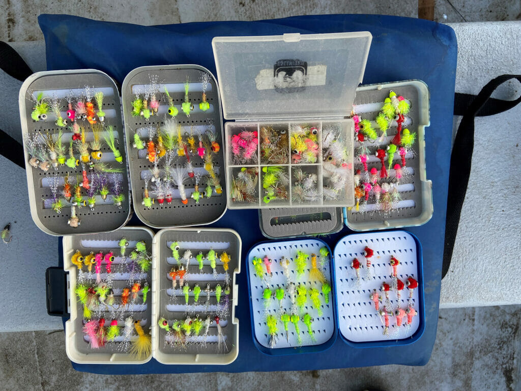Many containers fill of colorful shad flies