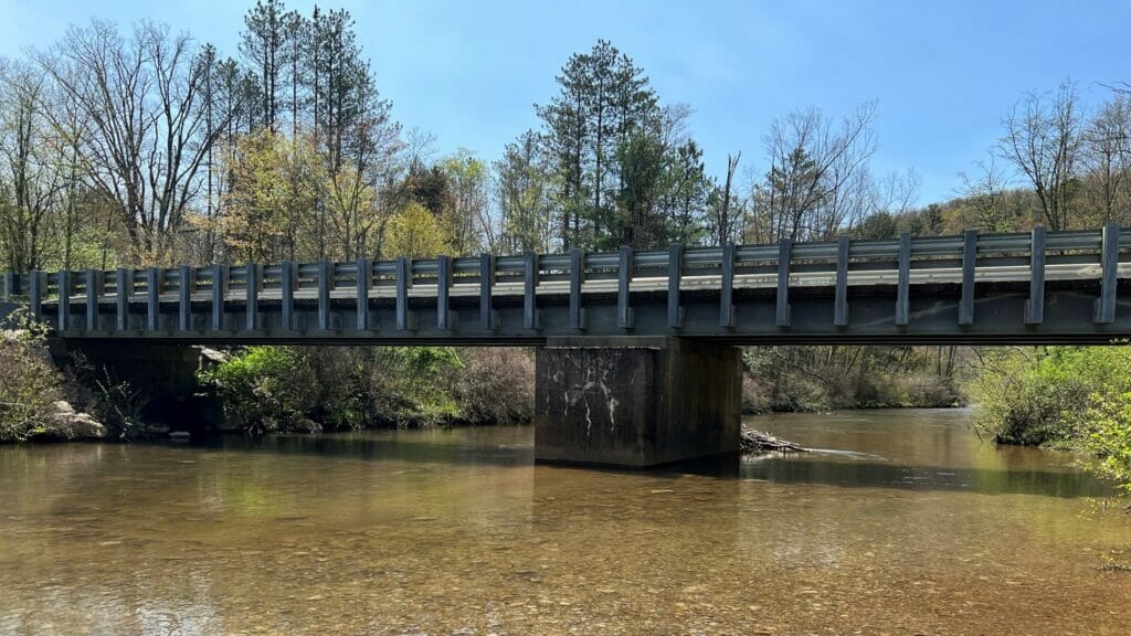 A small bridge going over a shallow creek