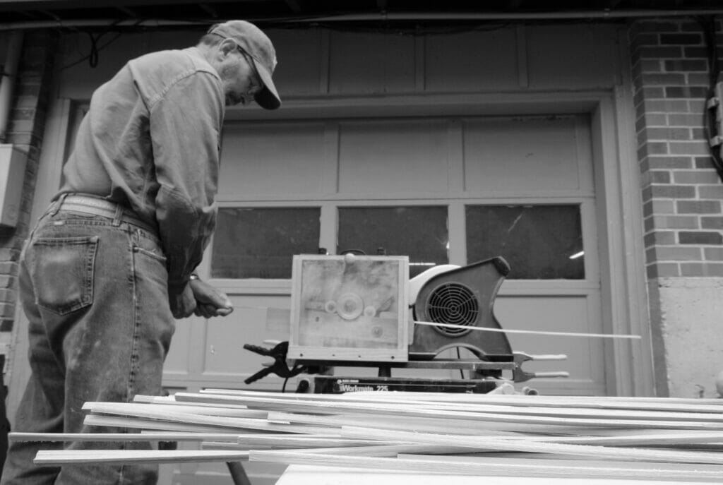 Black and white photo of man wood workinga