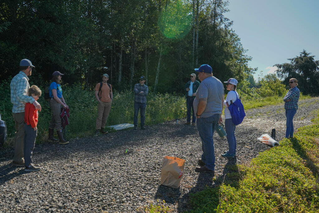 Group of people standing next to the woods