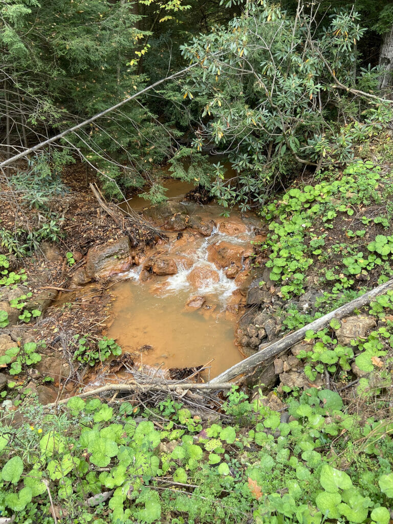 A creek flowing over red rocks