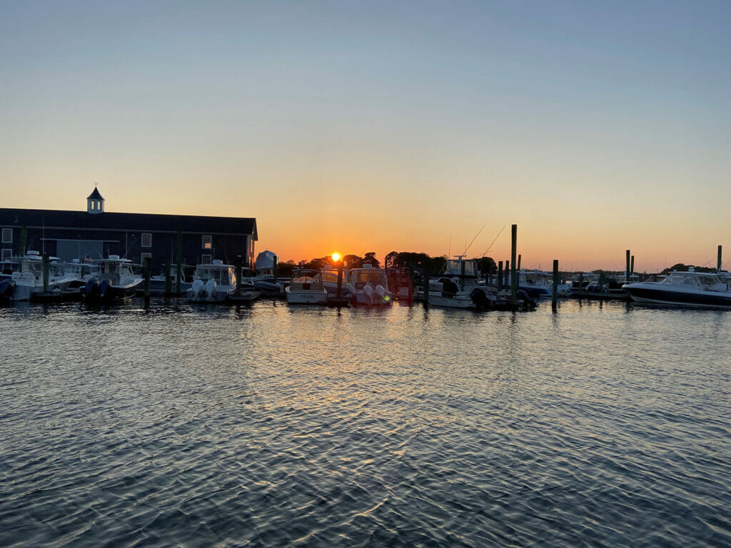 Sun setting behind docked boats