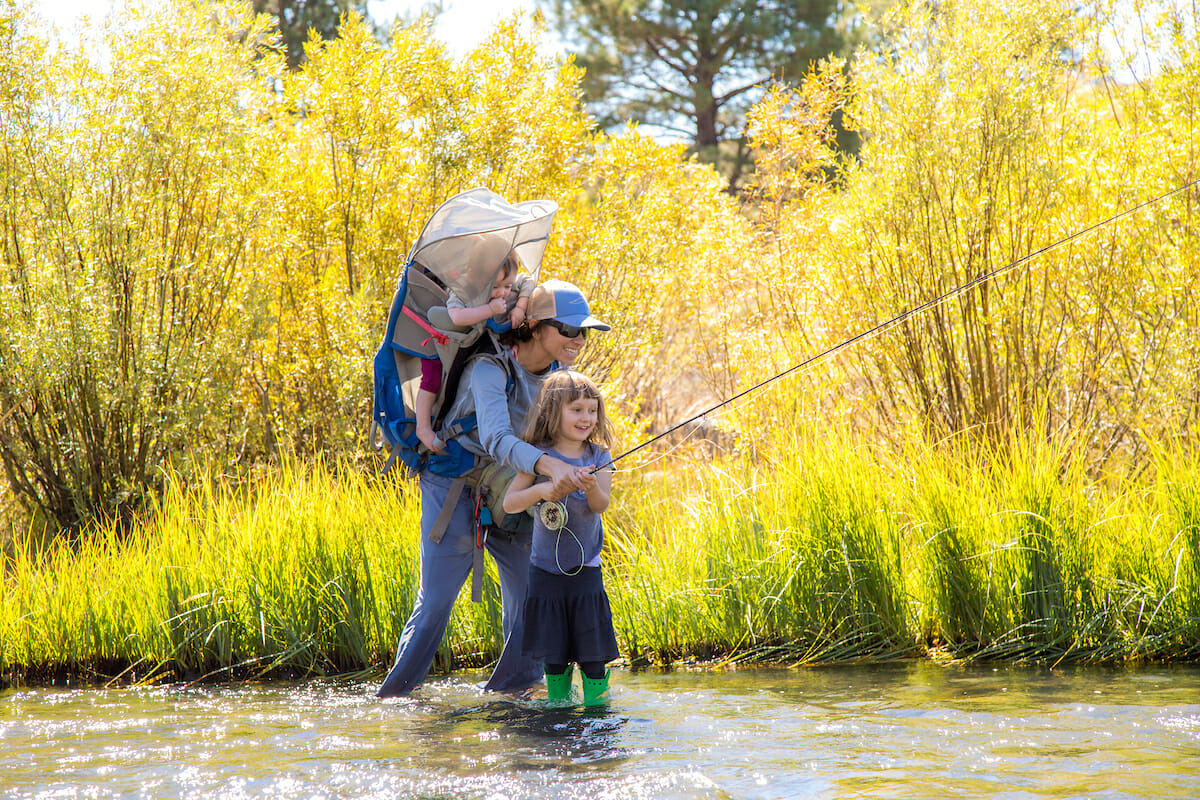 Woman helps daughter fish