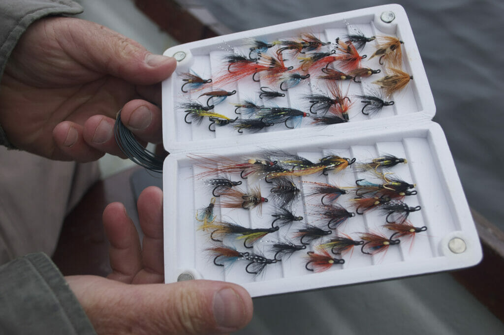 A container of fly fishing flies