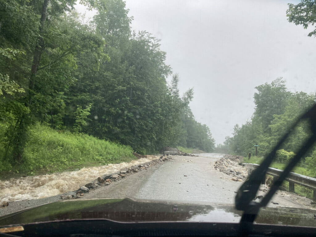 Rain water collects on the side of a road threatening to flooding