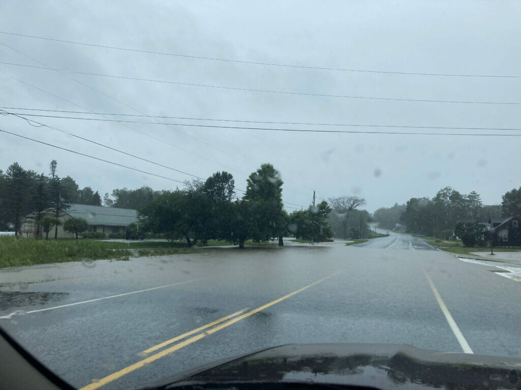 Rain water threatens to flood over a road