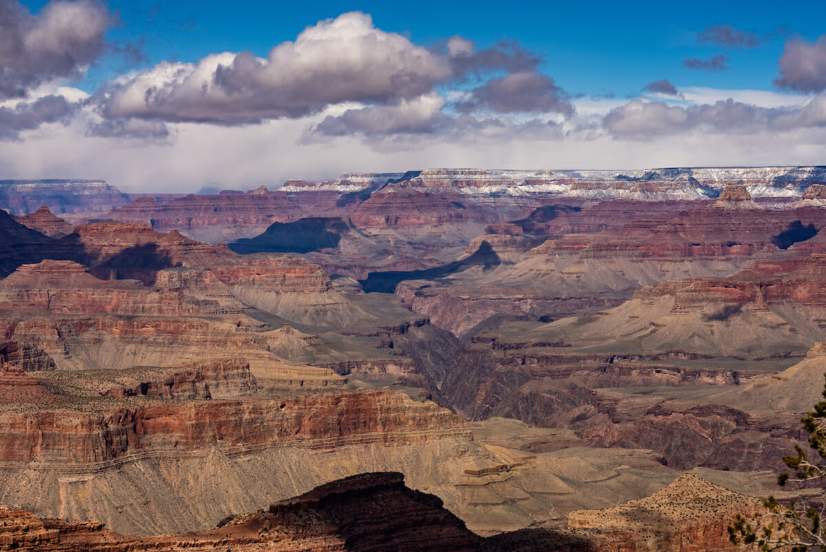 The Grand Canyon with snow at the rim and low hanging clouds