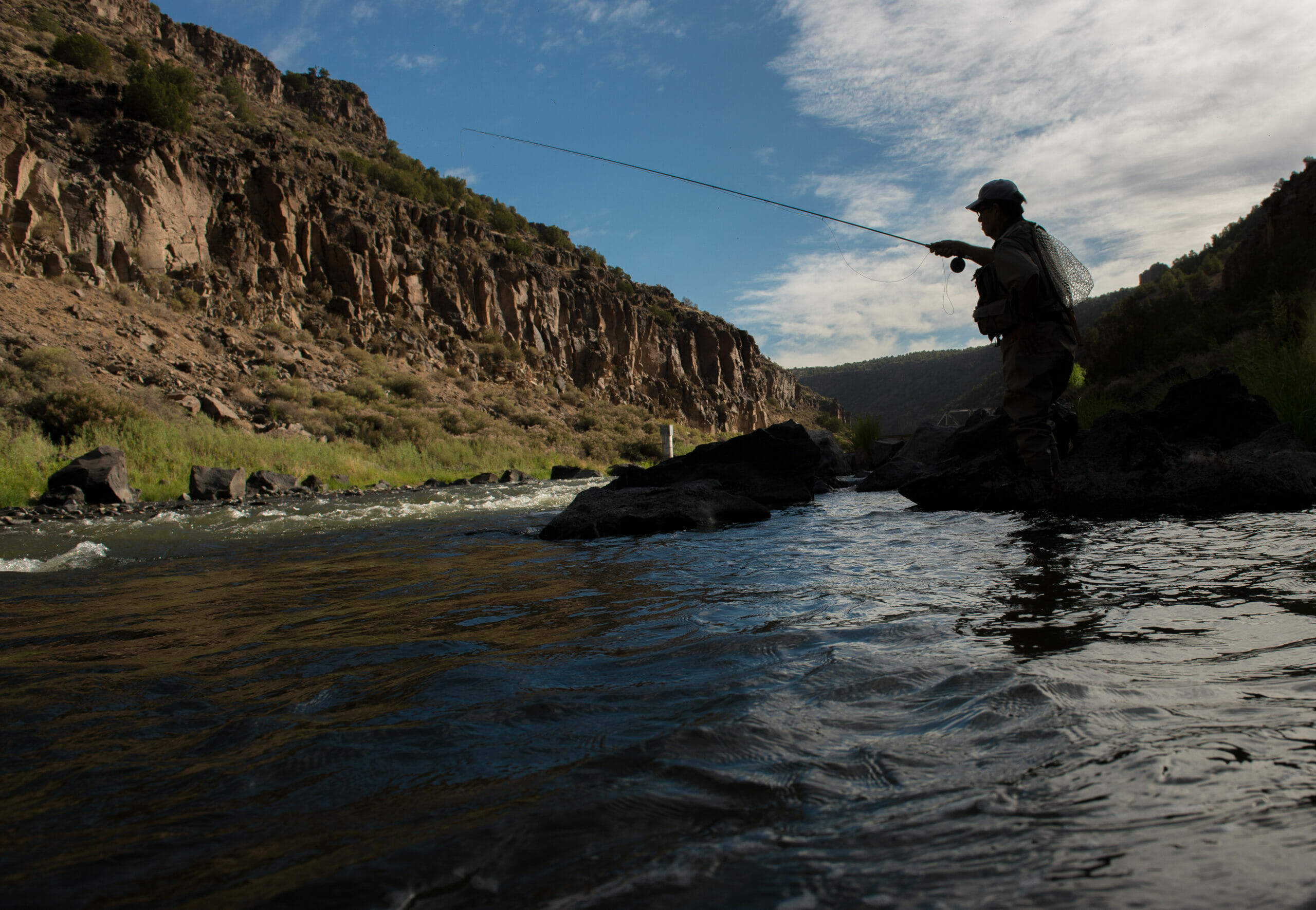 Silhouette of man fishing