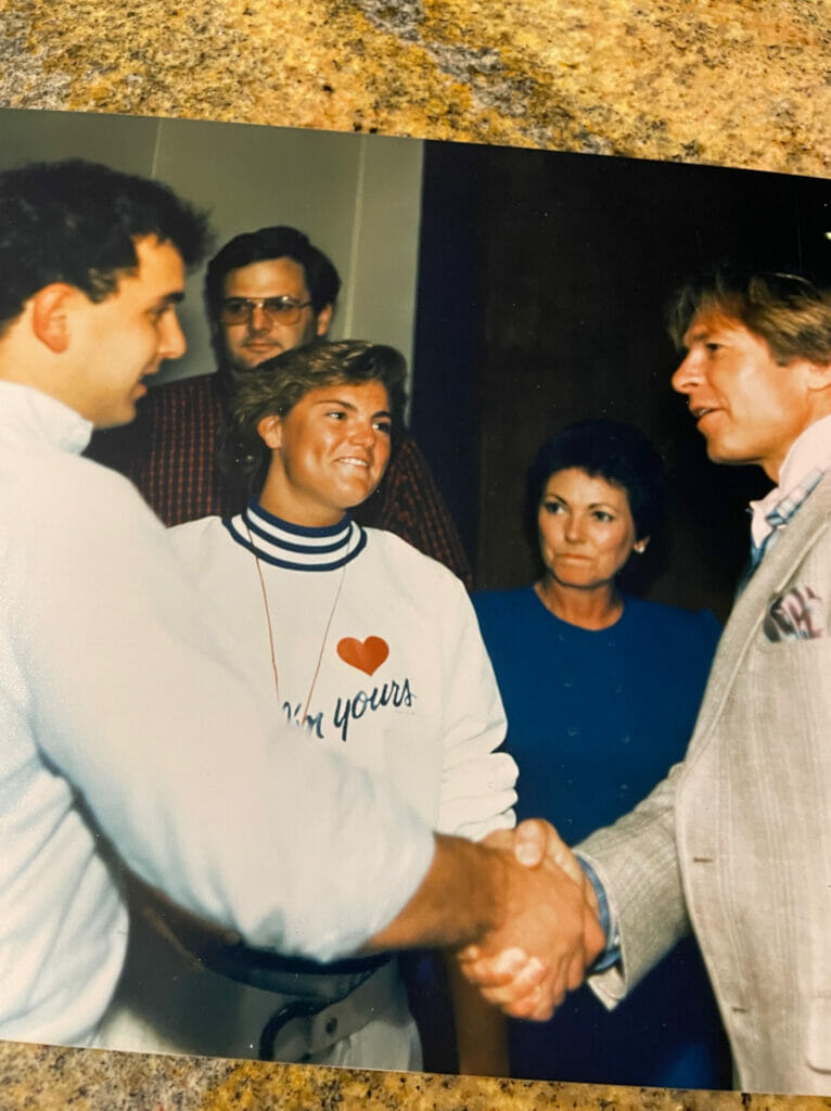 John Denver shaking hands with a young man.