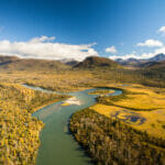 Areal view of river running through wooded mountains