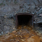 Mine entrance with polluted water coming out of it