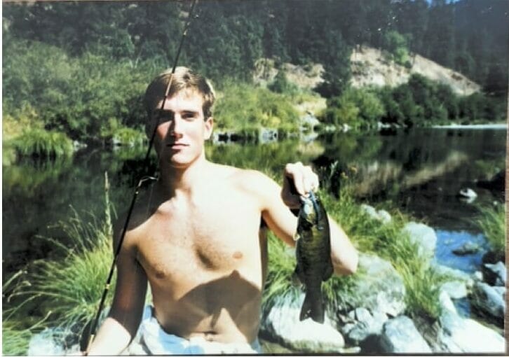 A man holding a fish in the 1980s wondering about Release or Kill 