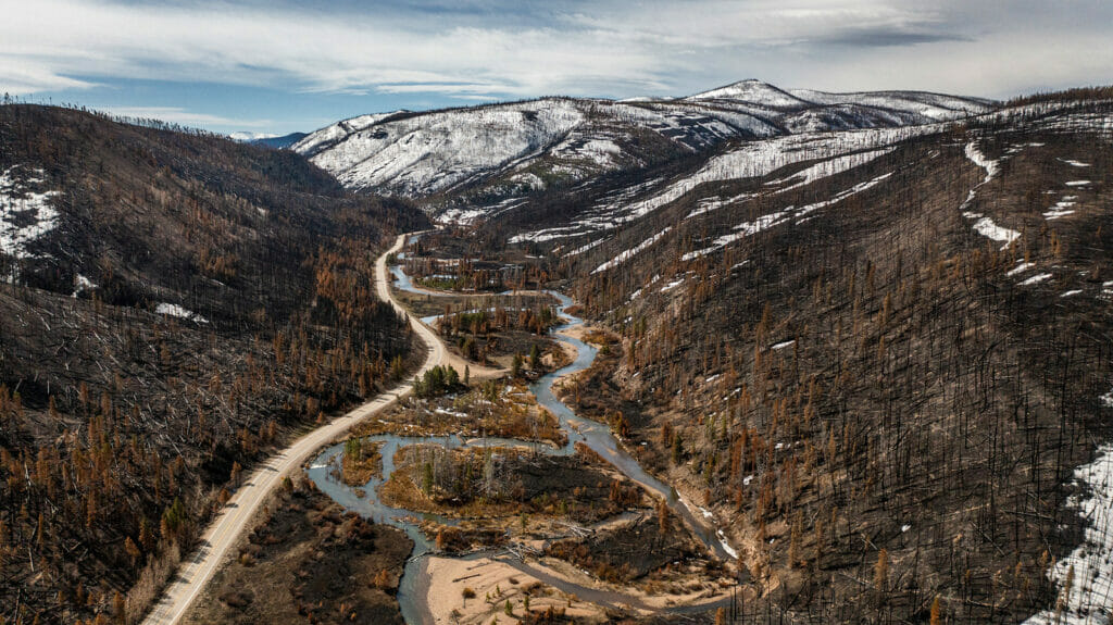 Areal view of charred landscape and mountains