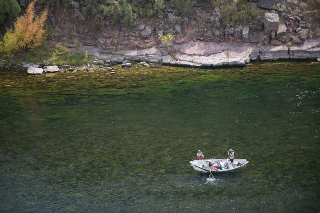 Birds eye view of a family fishing on a boat on a river