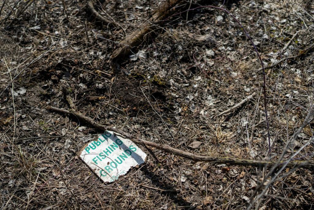 A piece of paper on the ground reading "Public Fishing Group"