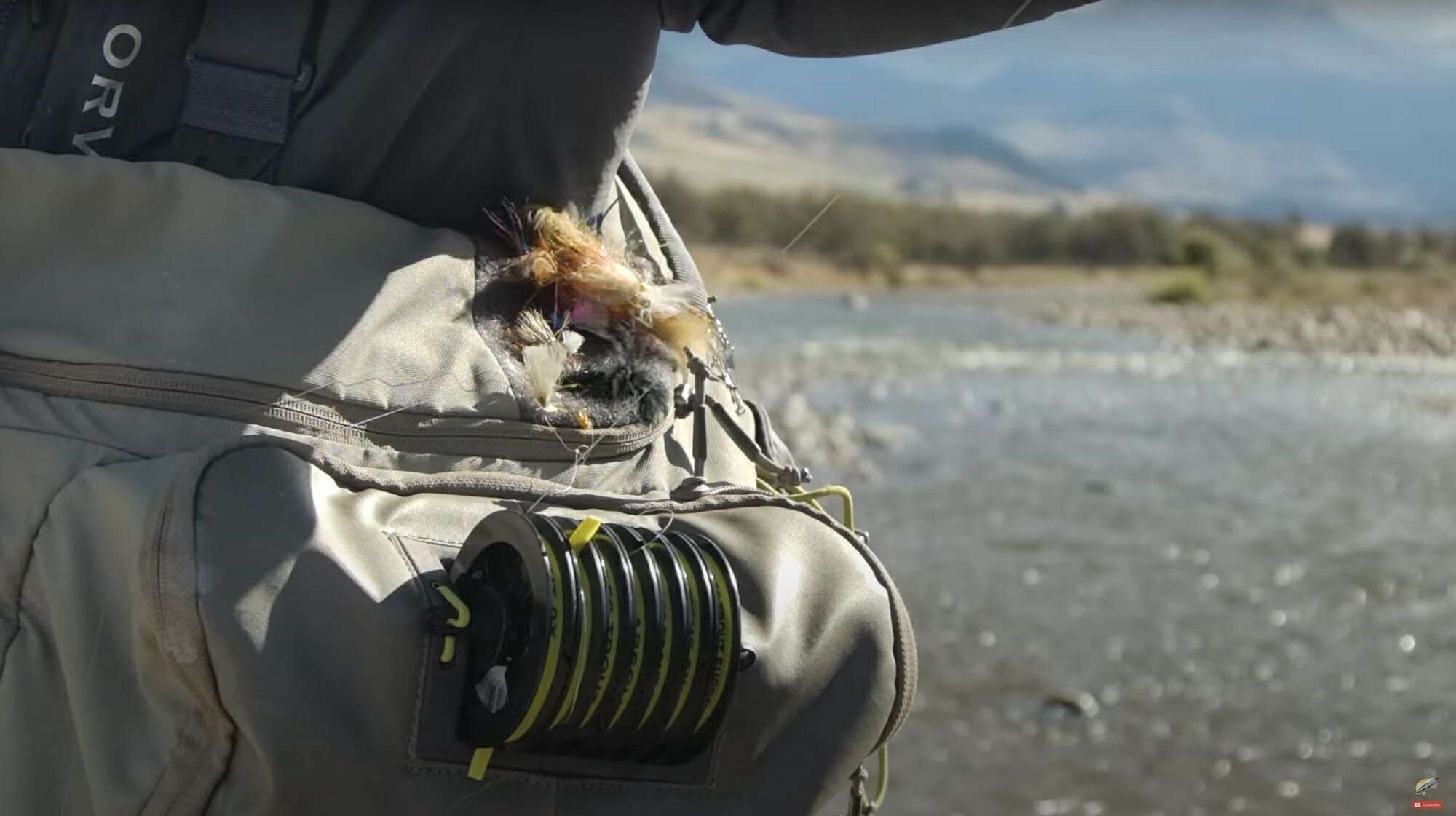 Close up of fishing equipment on someone's hip