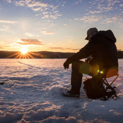 ice fishing at sunset
