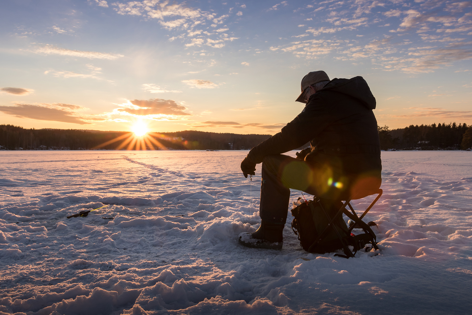 ice fishing at sunset