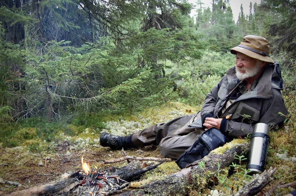 John Gierach next to a fire portrait by Bob White