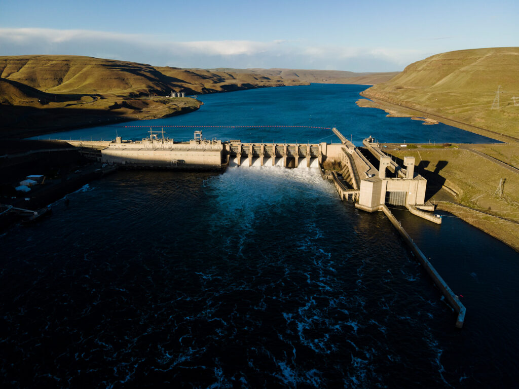 floodgates open wide view of monumental dam on snake river