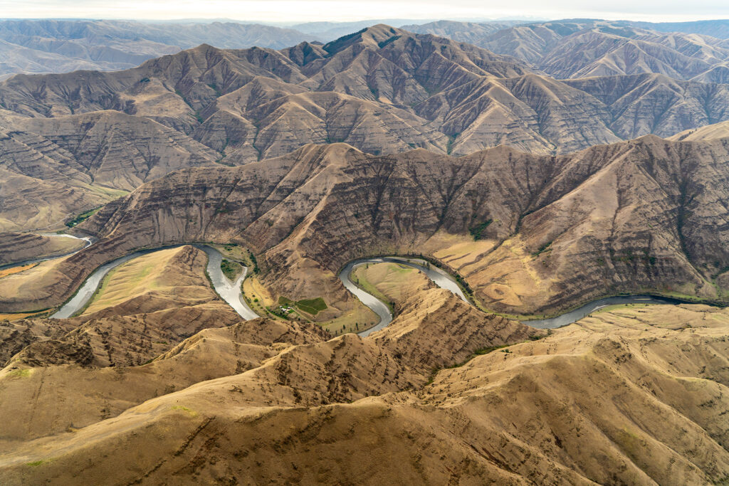 snake river path winding through mountains from above 