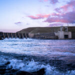 floodgates open at monumental dam on snake river at sunset