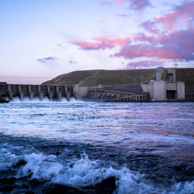 floodgates open at monumental dam on snake river at sunset