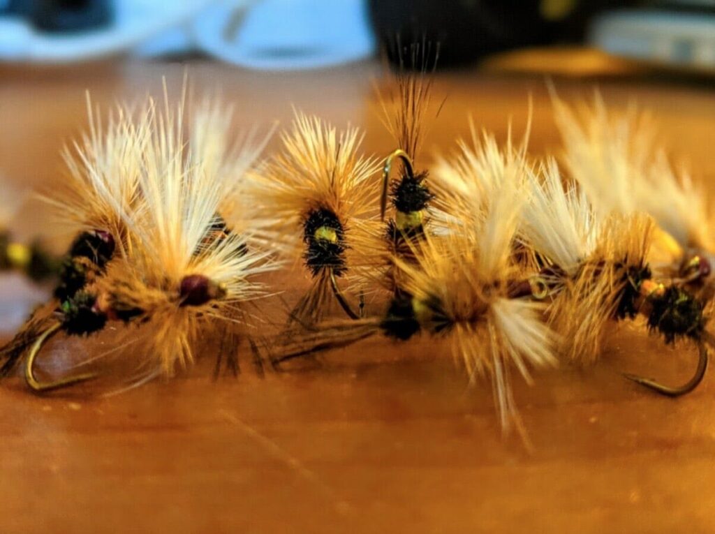 close up of dry flies on a table