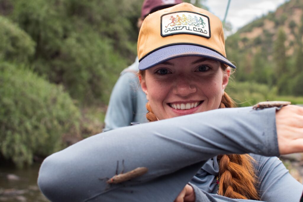 angler watching nymphs on her sleeve