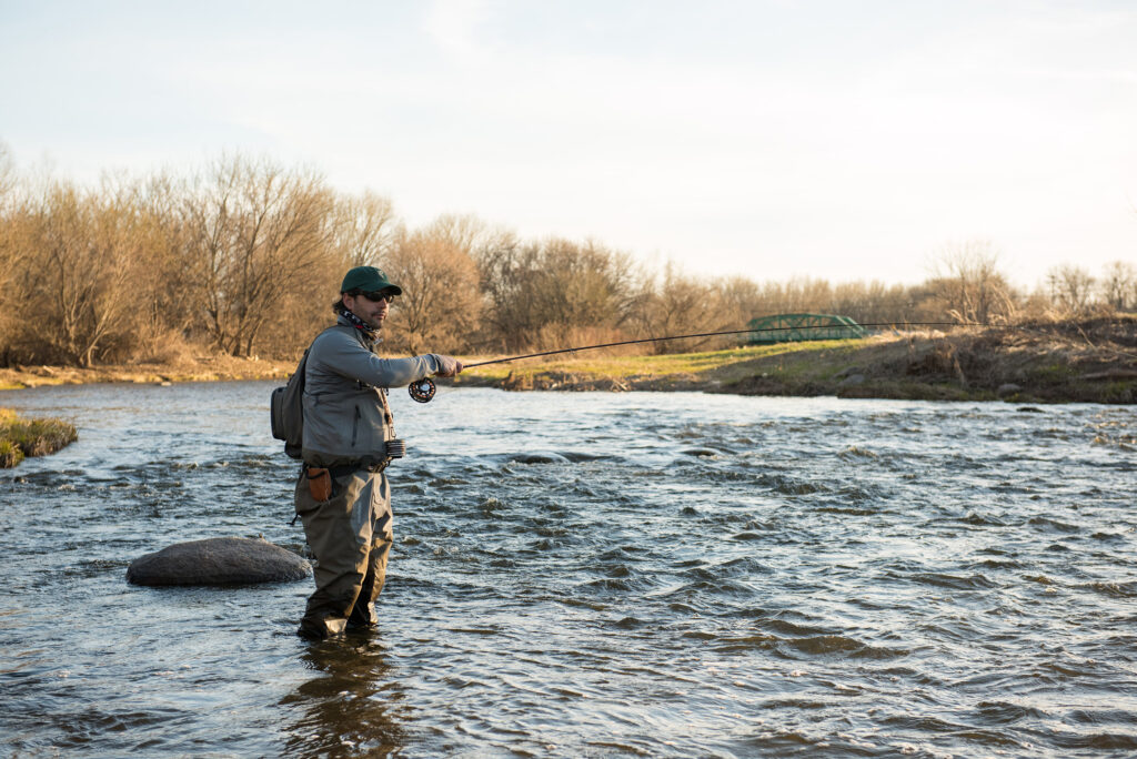 man in the river fly fishing showing a human wrote the review and fished with the product
