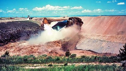 Teton Dam breach showing water crashing through dam